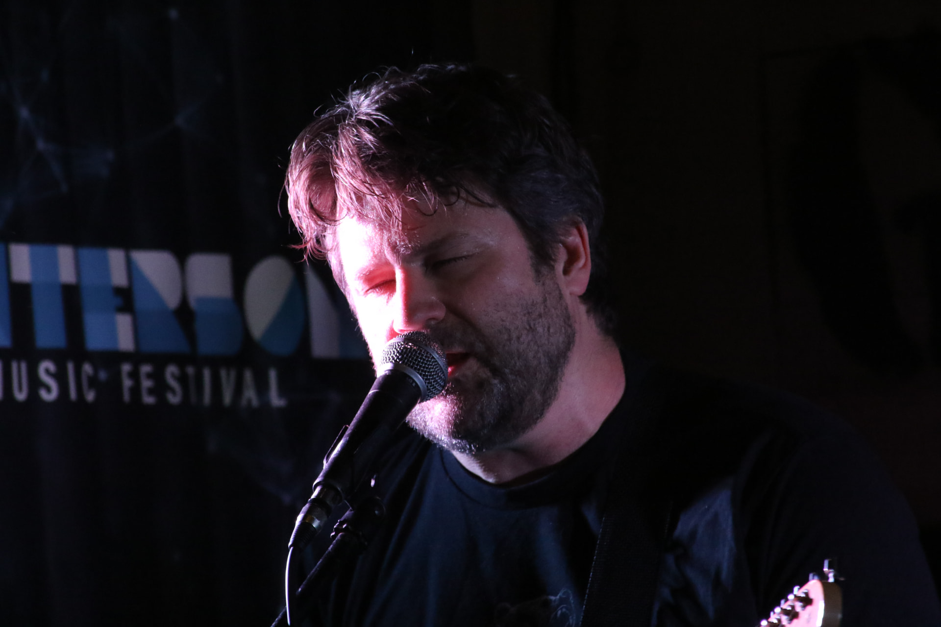 Kevin singing into the mic at the Wintersong Music Festival