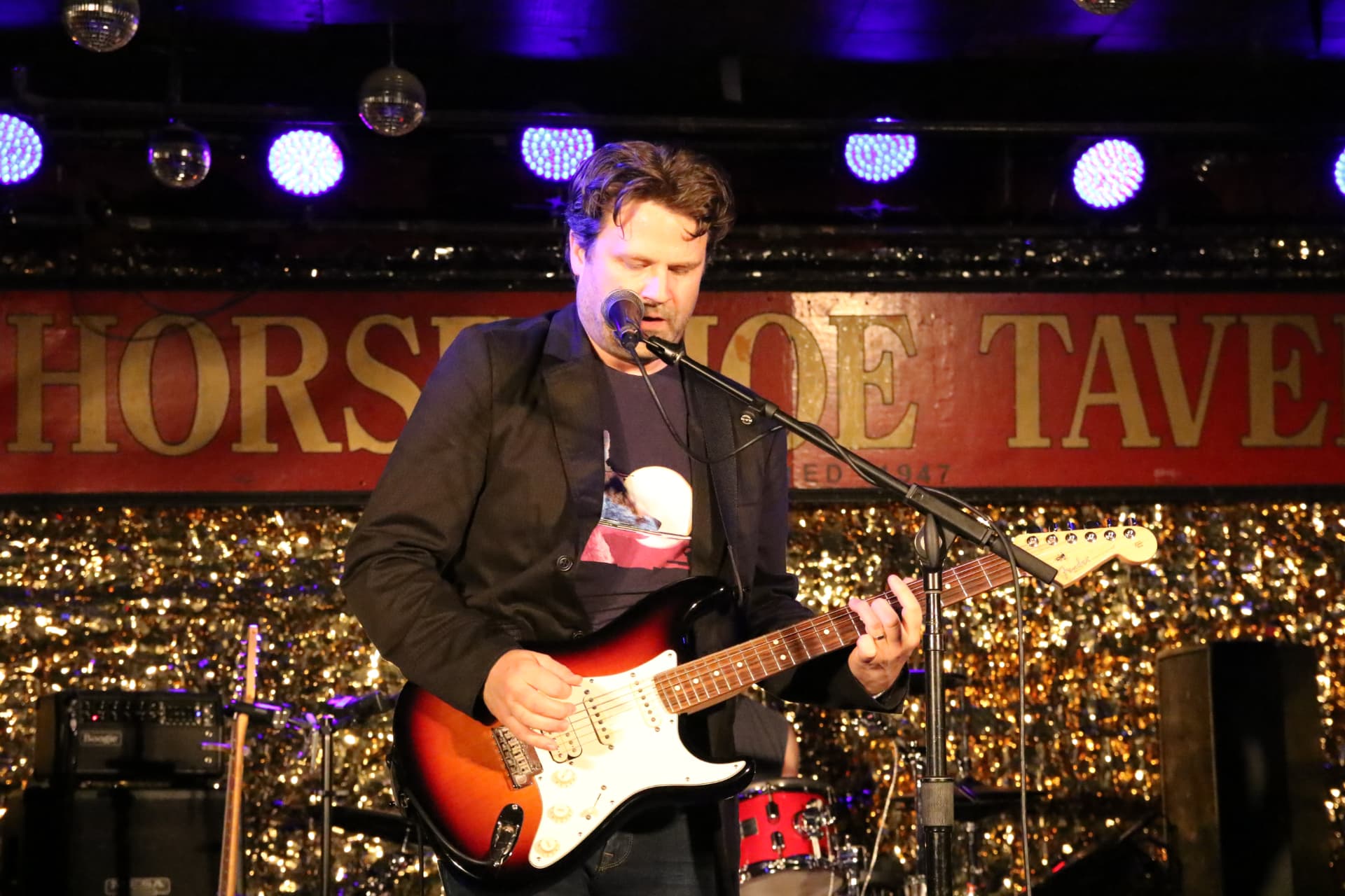 Kevin singing and playing a sunburst Stratocaster at the Horseshoe Tavern