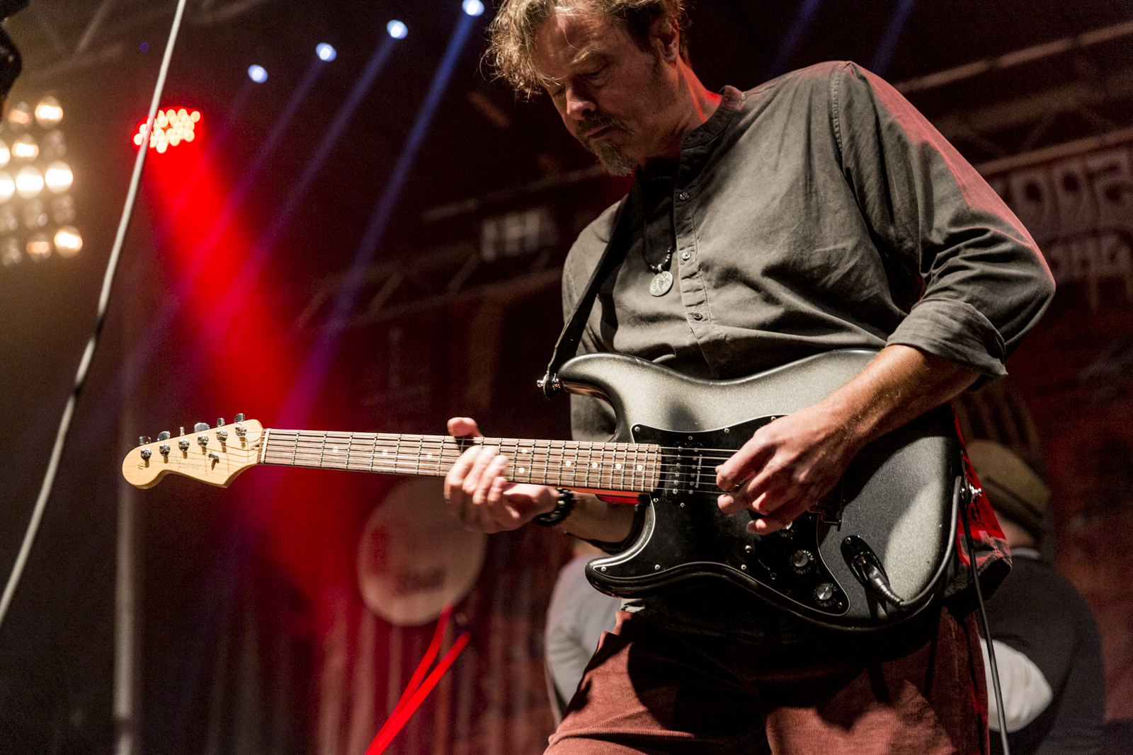 Guitarist under red and blue stage lights
