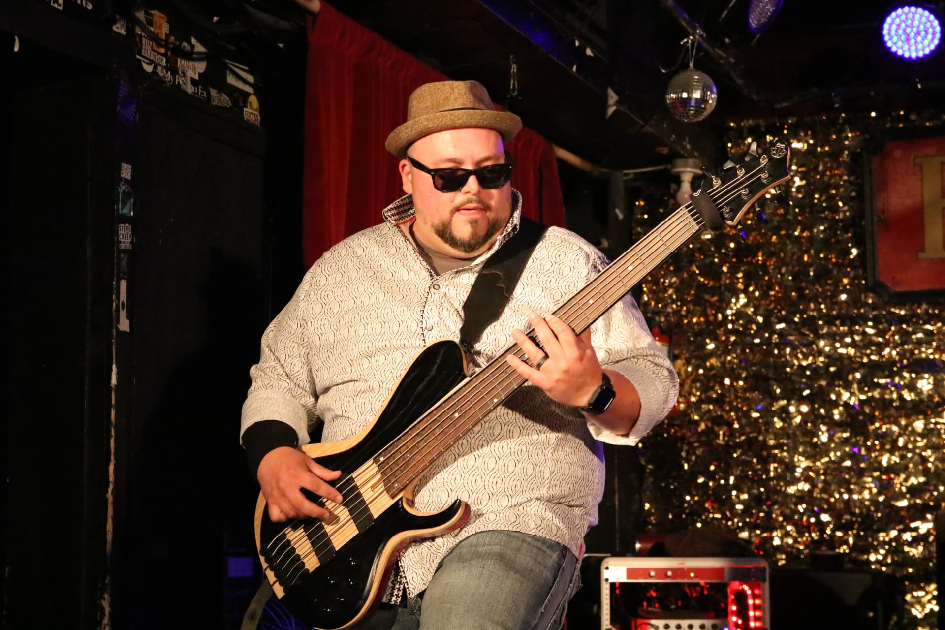 Matt in a fedora and sunglasses playing a six-string bass at the Horseshoe Tavern